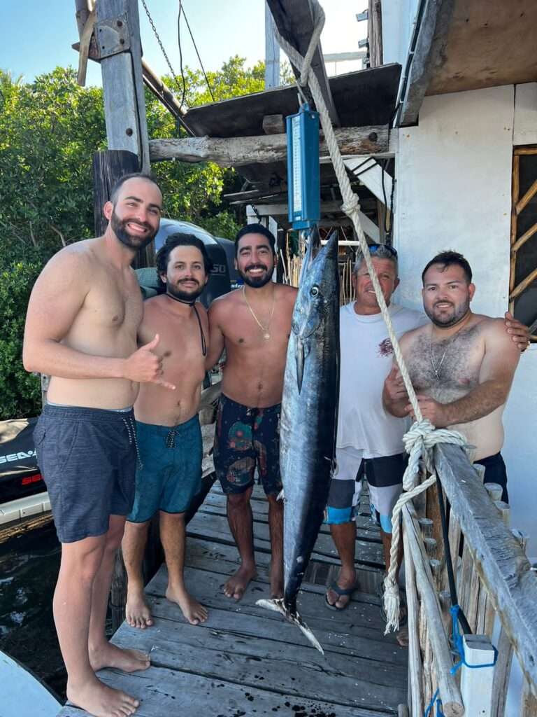Group of anglers with a big catch at the marina