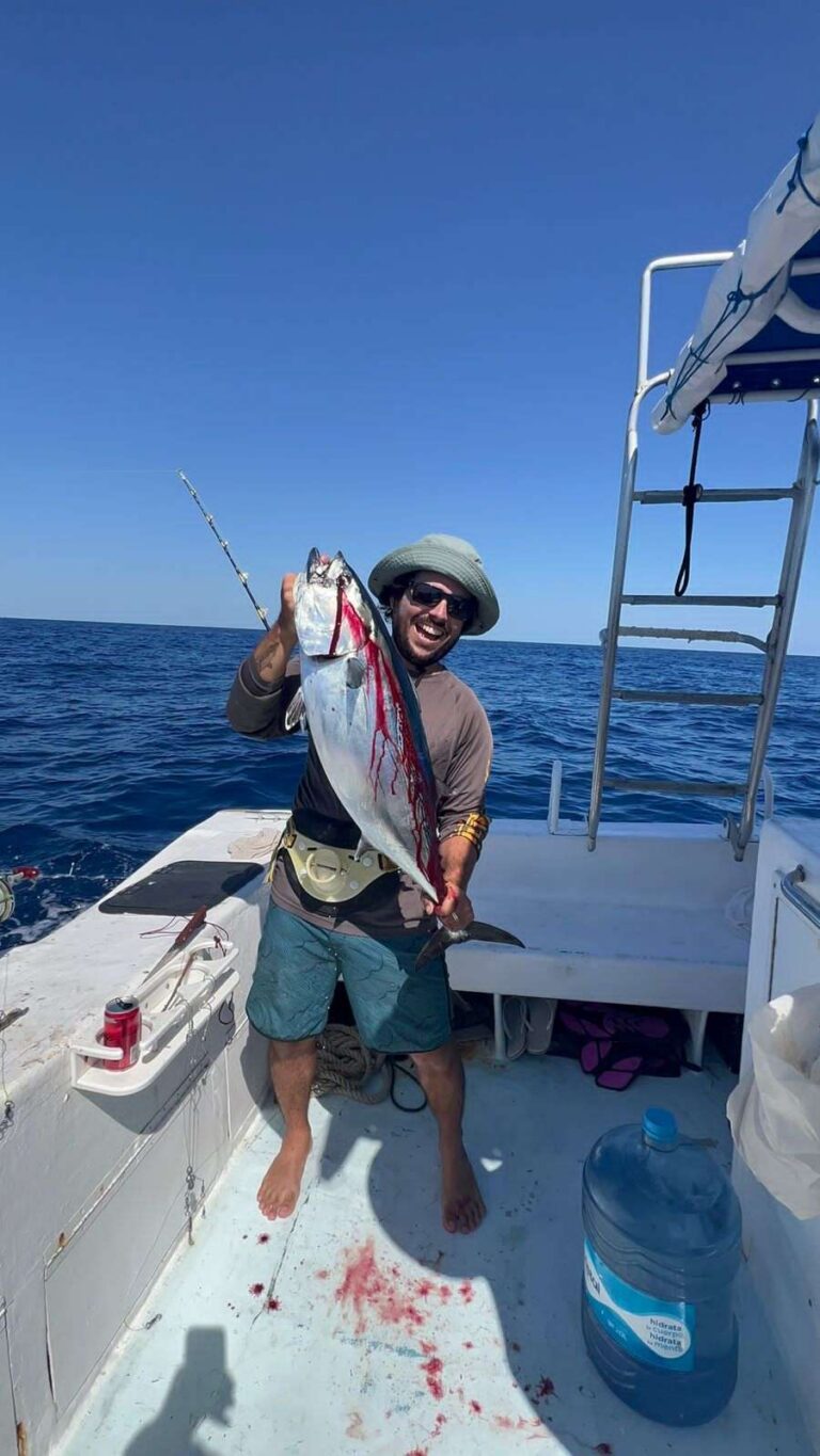Angler holding a tuna on the fishing boat
