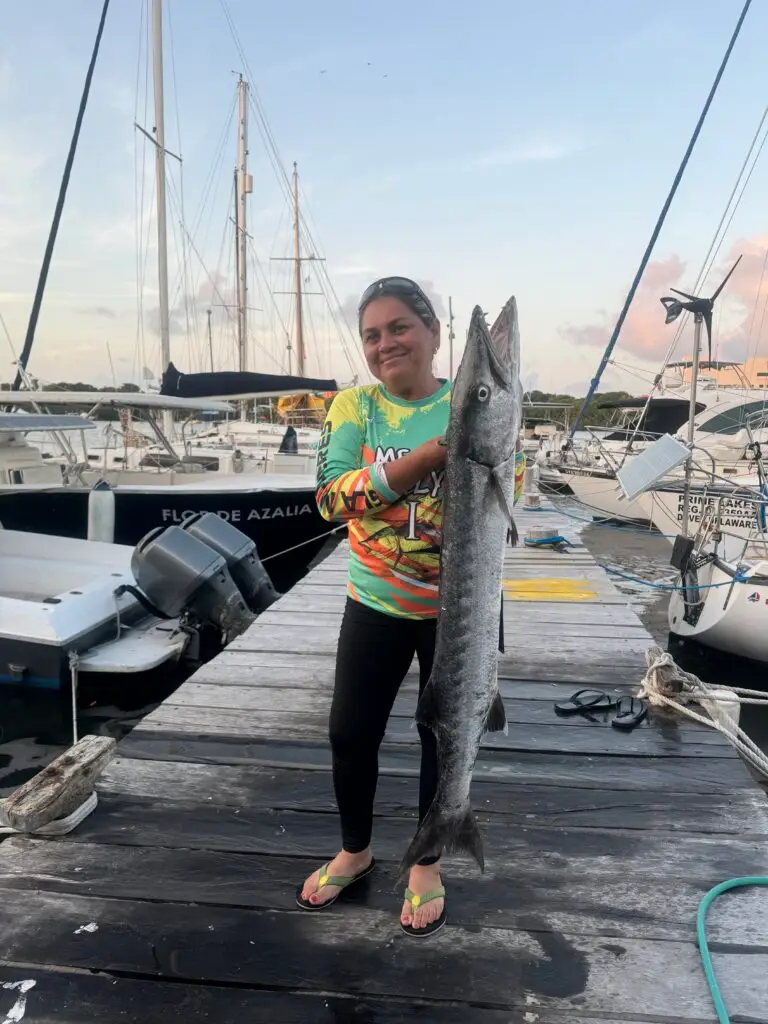 Guest holding her catch at the Isla Mujeres marina