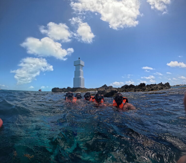 Snorkelers in front of the El Farito lighthouse, Isla Mujeres