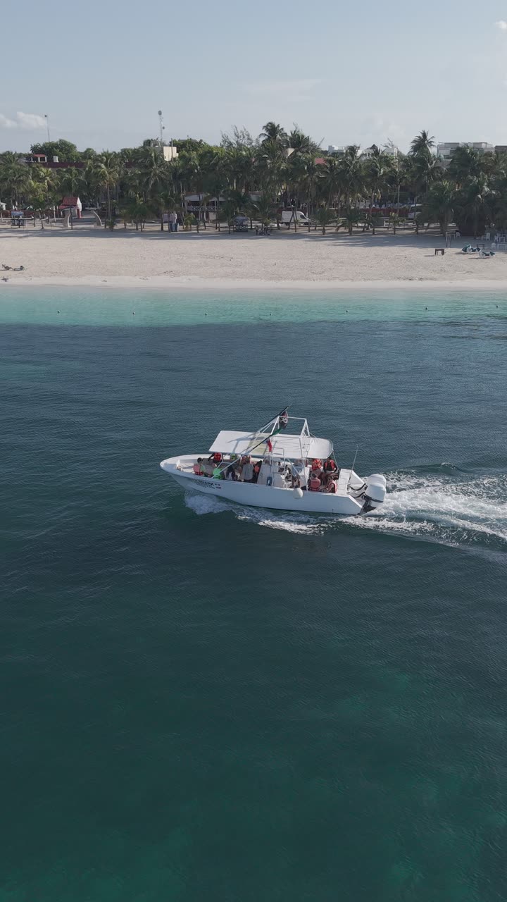 Drone view of a tour boat along the Isla Mujeres beach