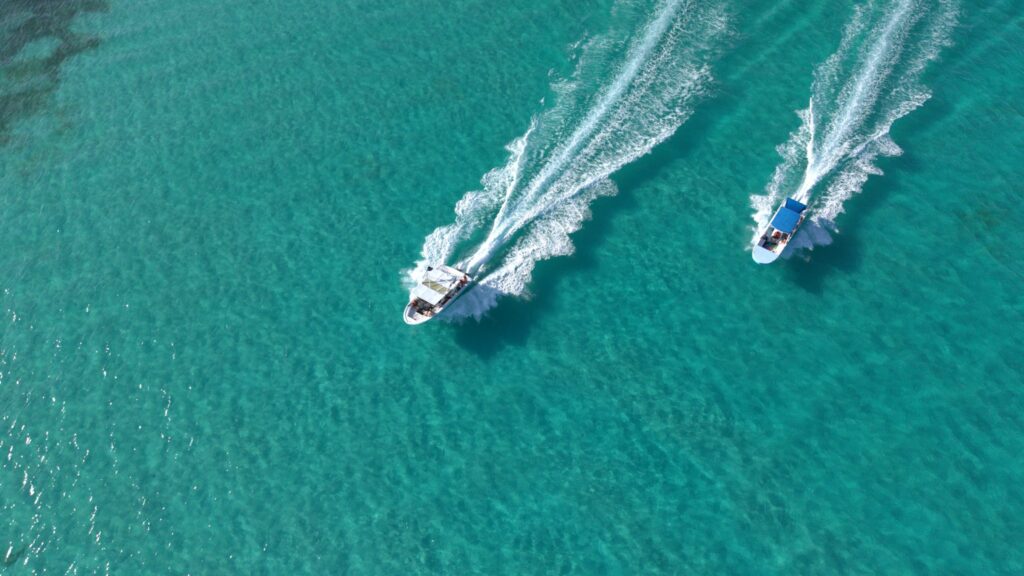 Aerial view of two tour boats over turquoise water near Isla Mujeres
